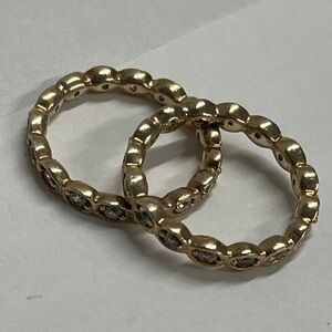 Set of 2 Sz 7. 75 gold-toned eternity band rings bezel-set clear zirconia stones